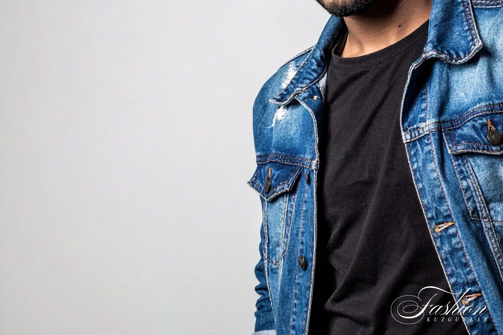 Man in a mid-wash denim jacket over a black T-shirt